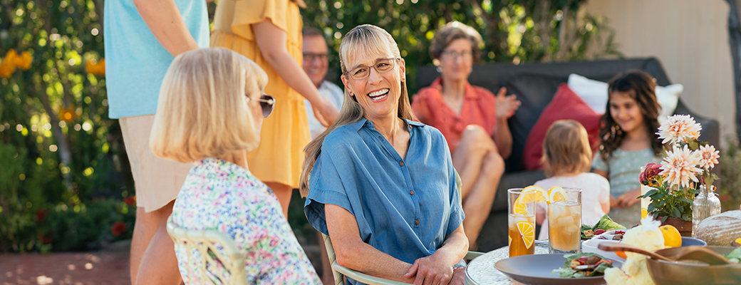 Image of woman speaking to her female friend at a gathering